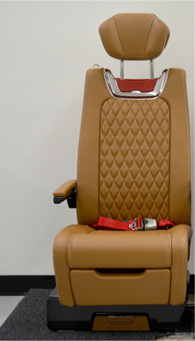 Brown upholstered Phenom 300 seat prototype with headrest and armrests