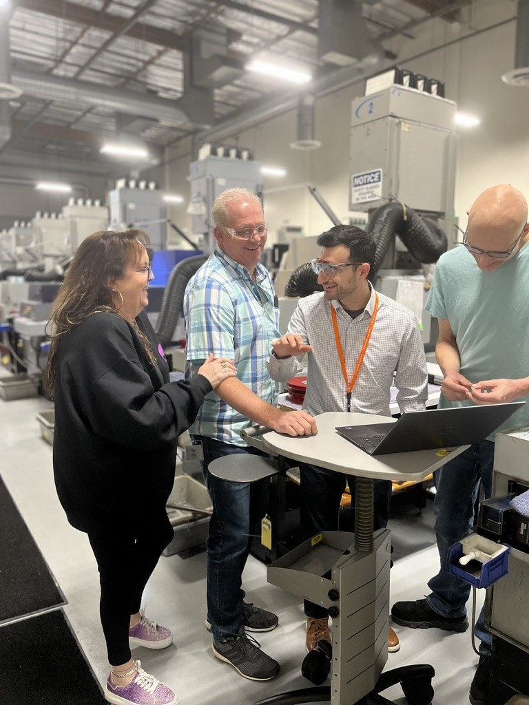 Shaunt sharing a lighthearted moment with colleagues on the manufacturing floor