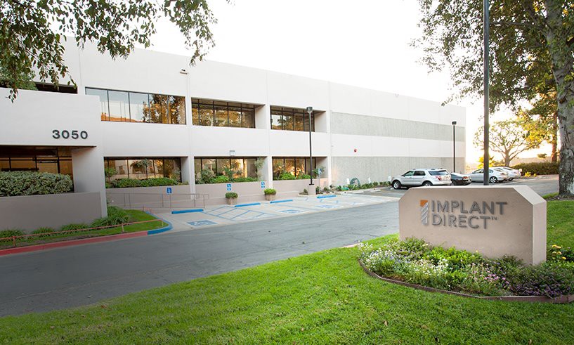 Exterior of the Implant Direct facility with the company sign